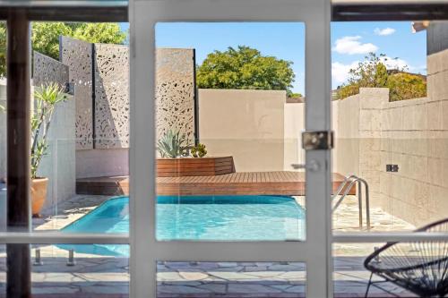 a view of a swimming pool through a door at Tropical Zen Stylish Beach-Inspired Home w Pool in Perth