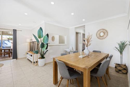 a dining room with a wooden table and chairs at Rivervale Family Retreat Quiet 3BR Home Near Swan in Perth
