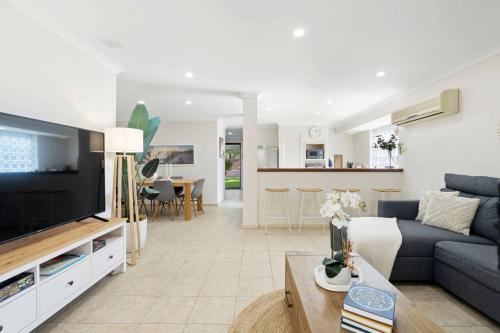 a living room with a couch and a tv at Rivervale Family Retreat Quiet 3BR Home Near Swan in Perth