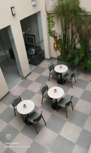 a patio with tables and chairs in a building at Lima Atelier Boutique in Lima