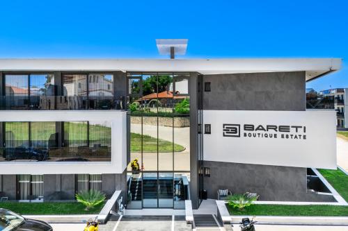 a building with a sign that reads gate north living at Bareti Boutique Estate in Kallithea Halkidikis