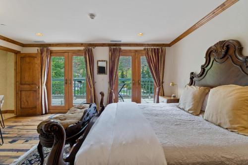 a large bedroom with a large bed and windows at 12 Vail Road - Unit 8 in Vail