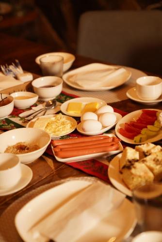 a table topped with plates and bowls of food at Hotel Hobbiton near Vardzia Caves in T'mogvi
