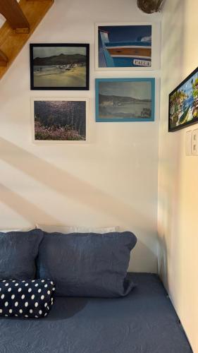 a room with a bed with pictures on the wall at Morada Vó Rita in Florianópolis