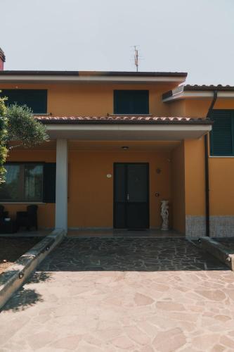 a yellow house with a driveway in front of it at Villa Desiderio - Trabocchi Coast - Fossacesia in Fossacesia