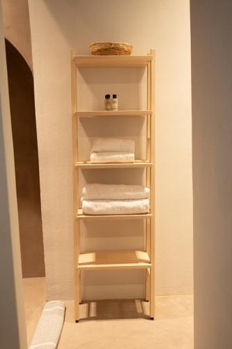 a towel rack in a bathroom with towels at Kimolos Arch House in Kimolos