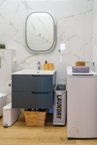 a bathroom with a sink and a mirror at Diamond A1 Luxury Inn in Iraklitsa