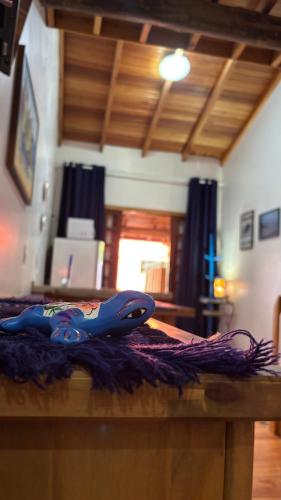 a blue scissors sitting on top of a wooden table at Morada Vó Rita in Florianópolis