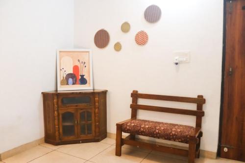 a room with a chair and a cabinet and a picture at The Jungle Retreat by Jabula Getaways in Dehradun
