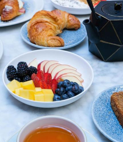 een tafel met daarop borden met fruit en croissants bij Concorde Hotel New York in New York
