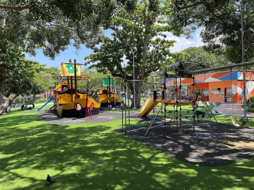 a park with several playground equipment in the grass at Lofts Mediterraneo in Barranquilla