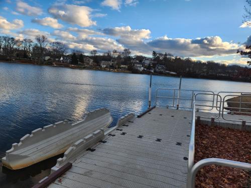 a dock with chairs on the side of a lake at The Fairview in Peabody
