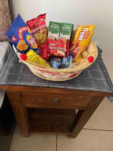 a basket of chips and snacks on a table at The Jungle Retreat by Jabula Getaways in Dehradun