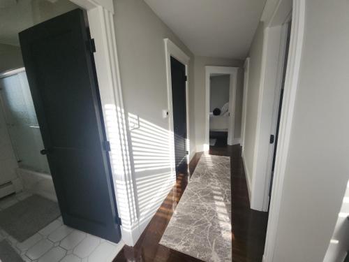 a hallway with a blue door and a tile floor at The Fairview in Peabody
