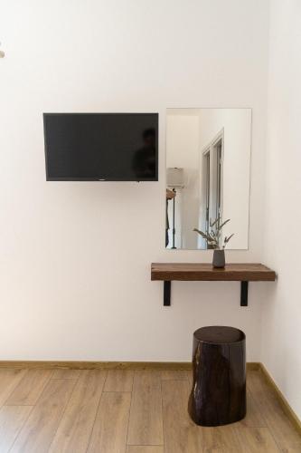 a flat screen tv hanging on a wall in a room at Ollenia's Harmony Luxury Apartments in Derveni