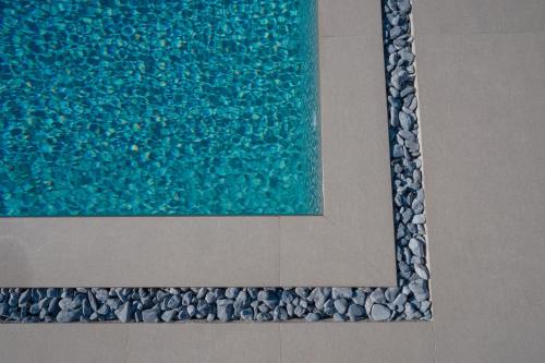 a painting of a pool of water on a wall at Ollenia's Harmony Luxury Apartments in Derveni