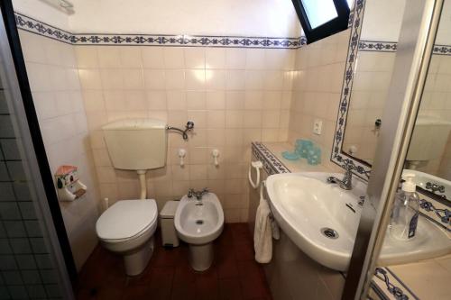 a small bathroom with a toilet and a sink at Villa Pedras d'el Rei - 1 room 4 people in Santa Luzia