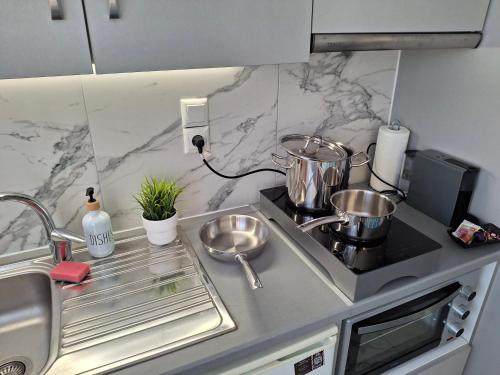a kitchen with a sink and a counter top at Vaso's nest at Patras Center in Patra