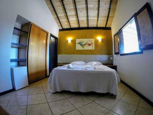 a bedroom with a large bed in a room at Pousada Village da Serra in Santana do Riacho
