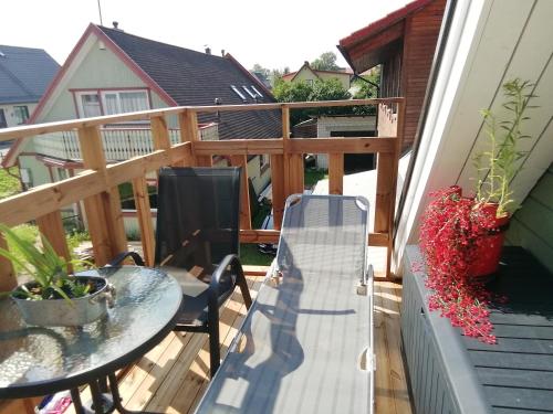 a balcony with a table and a bench on a deck at Stuudio 7,Otepää linn 67404,Valgamaa in Otepää