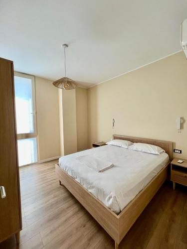 a bedroom with a large bed and a large window at Elite Vila with Pool, Green Coast in Palasë