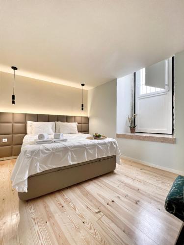 Uma cama ou camas num quarto em Azzulea Rossio Suites