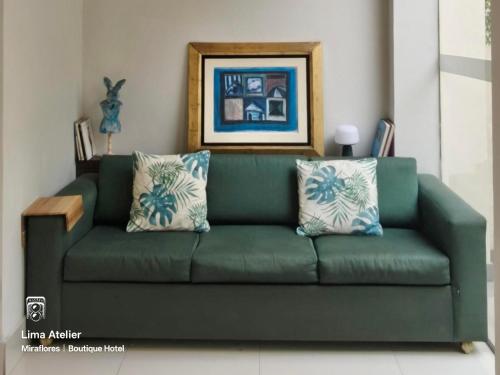a green couch with pillows in a living room at Lima Atelier Boutique in Lima