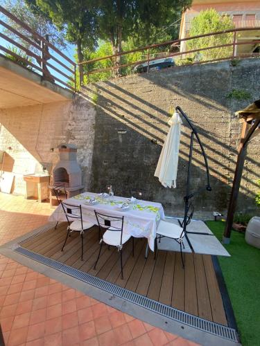 a table with chairs and an umbrella on a patio at Casa Rebecca in San Martino