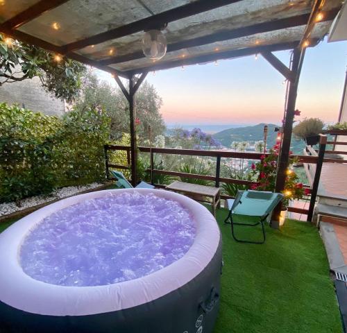 a jacuzzi tub on a patio with a view at Casa Rebecca in San Martino