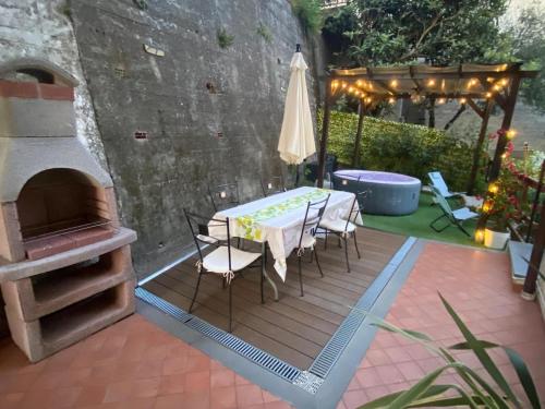 a patio with a table and an outdoor oven at Casa Rebecca in San Martino
