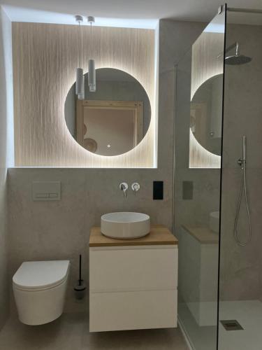 a bathroom with a sink and a toilet and a mirror at Dominickie Antresole in Boszkowo-Letnisko