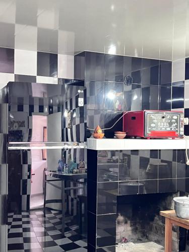 a kitchen with black and white tiles on the wall at Hotel Egrisi in Senaki in Senaki