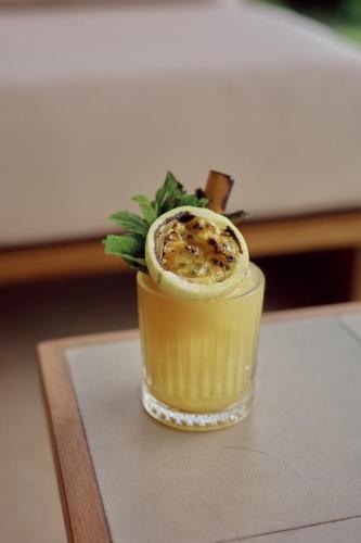 a drink in a glass sitting on a table at Sola - Boutique Hotel in Ahangama
