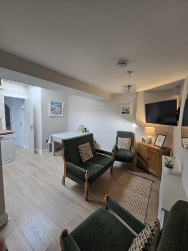 a living room with a couch and chairs and a table at Galway City - 135 Bohermore in Galway