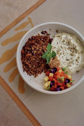 a bowl of food with nuts and vegetables on a table at Sola - Boutique Hotel in Ahangama