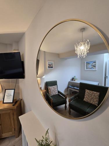 a mirror in a living room with a couch and chair at Galway City - 135 Bohermore in Galway