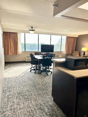 an office with a table and chairs and a desk at Best Western Plus Kelly Inn in Saint Cloud