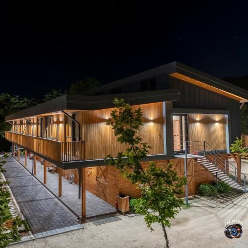 a house with lights on the side of it at Ecvestria Chalet in Ocnele Mari