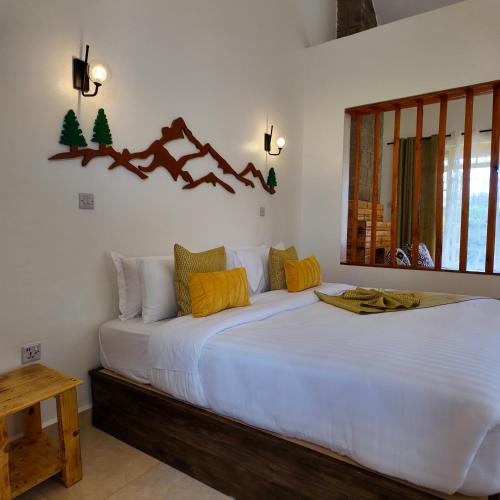 a bedroom with two beds and a window at Paradise Farm Cottages Mbui Nyeri in Ihua
