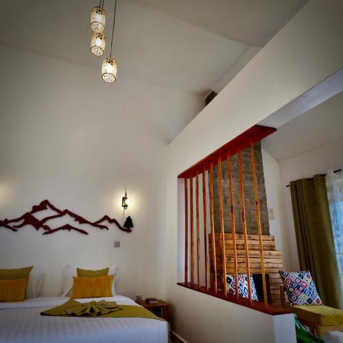 a bedroom with a bed and a window at Paradise Farm Cottages Mbui Nyeri in Ihua