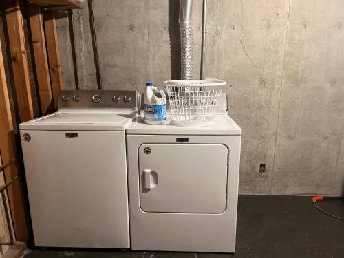 a small white refrigerator with a bottle of cleaner on it at Kings, 75" TV & Backyard Fun - NearWesley in The Dell