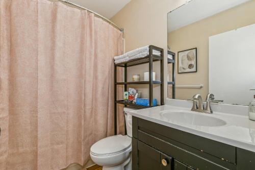 a bathroom with a sink and a toilet at Kings, 75" TV & Backyard Fun - NearWesley in The Dell