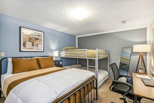 a bedroom with a bed and a desk and a bunk bed at Kings, 75" TV & Backyard Fun - NearWesley in The Dell
