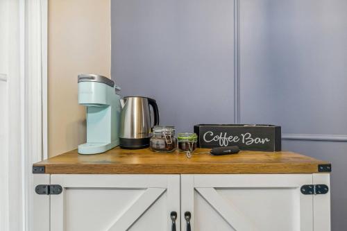 a coffee maker on a counter in a kitchen at Kings, 75" TV & Backyard Fun - NearWesley in The Dell