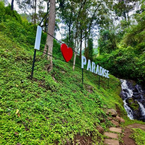 a sign that reads pandas and a heart on a hill at Paradise Farm Cottages Mbui Nyeri in Ihua