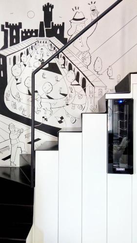 an escalator with a drawing of a city at QuickHome La Torretta in Asti