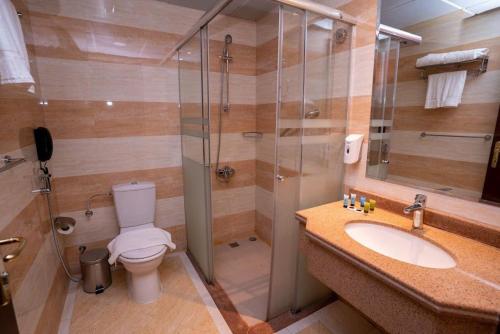 a bathroom with a shower and a toilet and a sink at Fundaq Warda safa 