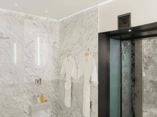 a bathroom with three mannequins on a wall at Hotel Maria Camille in San Miguel de Allende