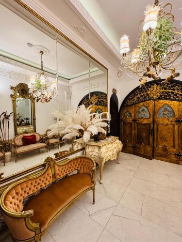 a large room with a couch and a mirror at Conacul Coroanei Luxury Boutique Hotel in Bucharest