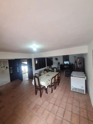 a large living room with a table and chairs at Casa Vila lagoinha in Lagoinha